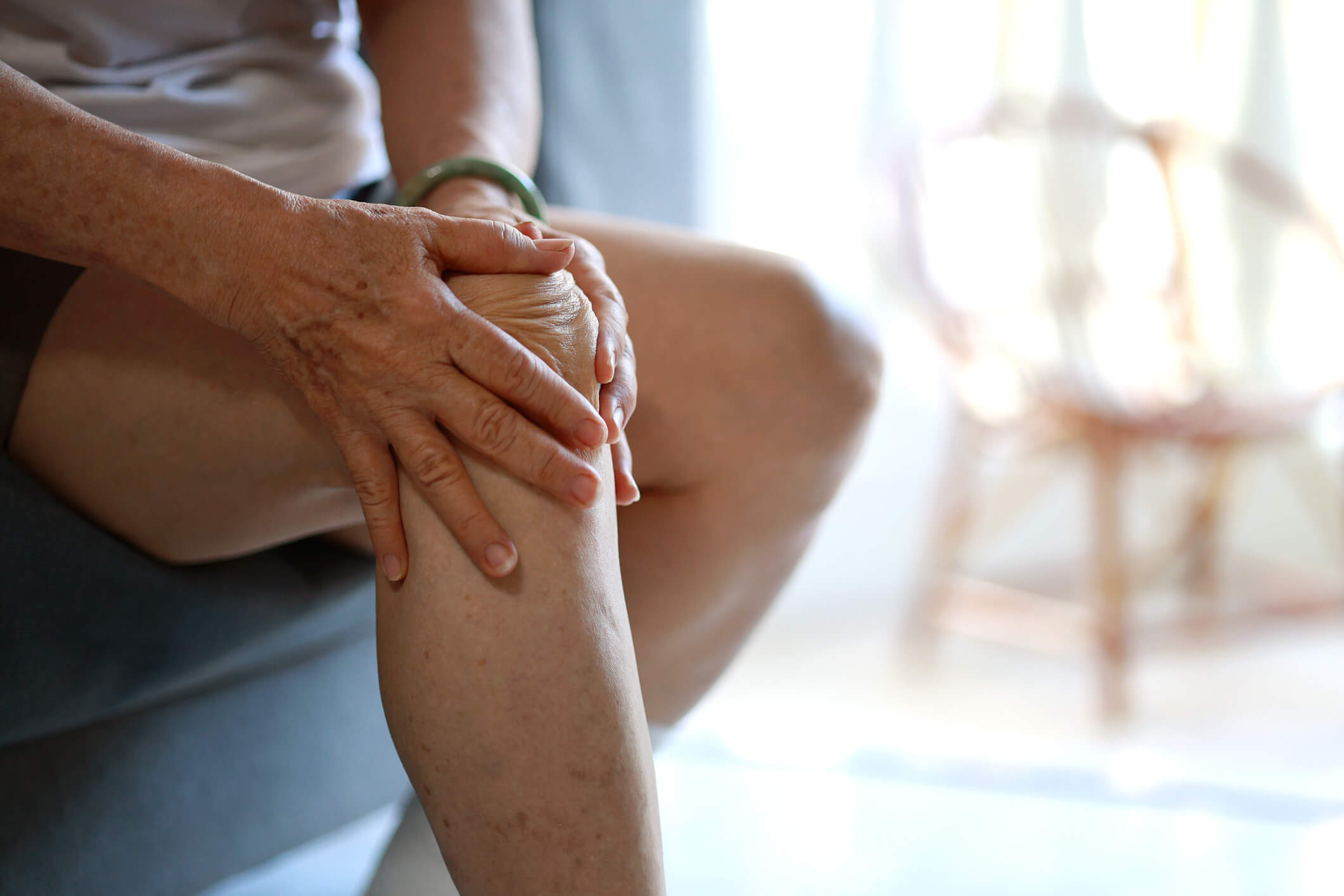 Close up of man with rheumatoid arthritis knee pain that could benefit from IV infusion therapy.