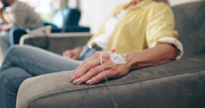 Image of the hand of a senior woman receiving IV therapy.