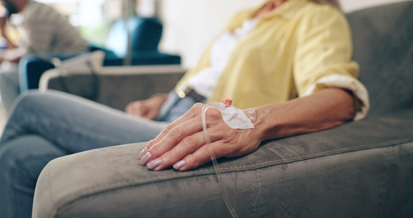 Image of the hand of a senior woman receiving IV therapy.