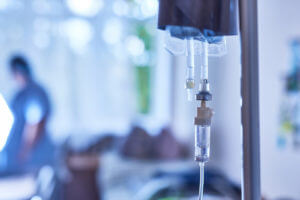 IV infusion therapy in a hospital room.