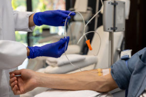 A male patient receiving IV therapy for psoriasis treatment in a hospital.