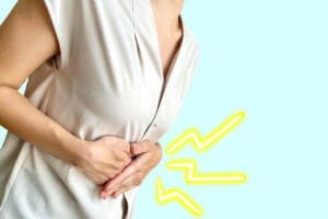 Woman with stomach ache due to ulcerative colitis.