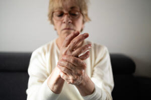 Senior woman suffering from arthritis pain in hands